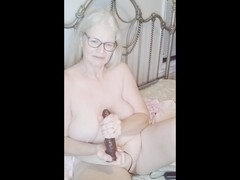 Busty mature babe with natural tits enjoys dildo play