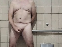 Senior man gets naked and jerks off in a spacious men's room stall